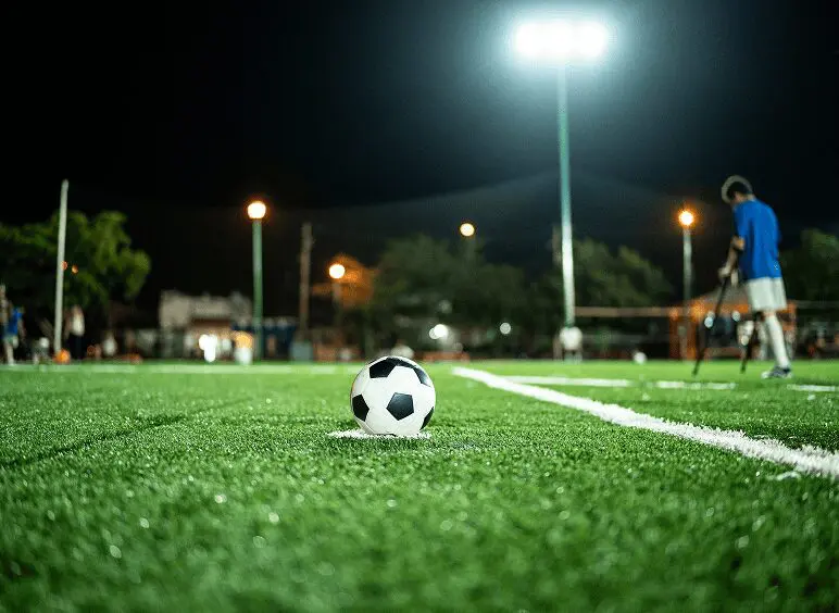 Nighttime soccer scene with a ball